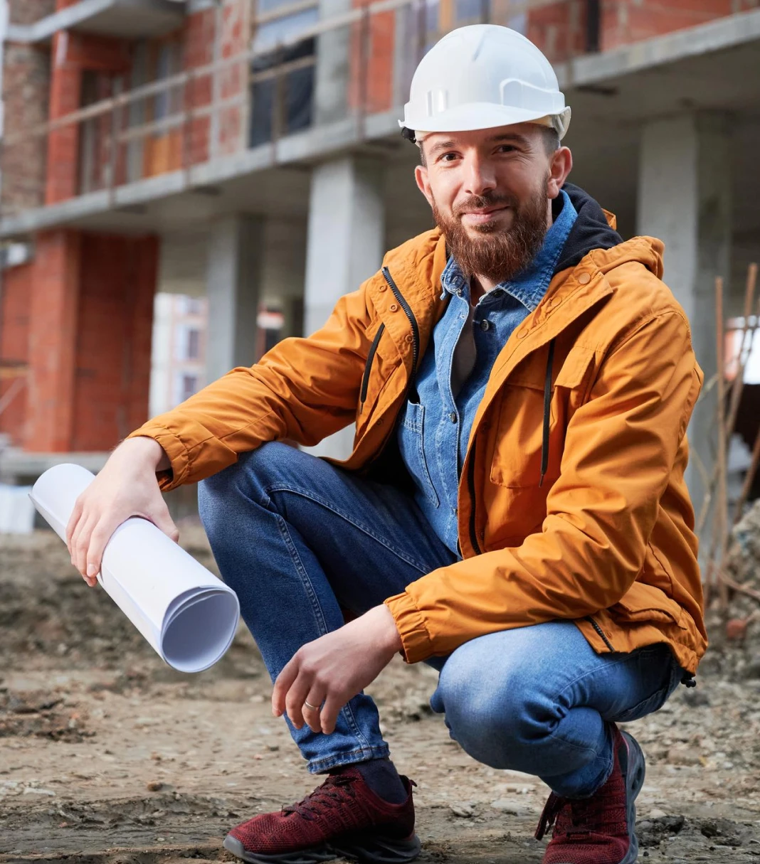 Expert en bâtiment examinant des plans sur un chantier